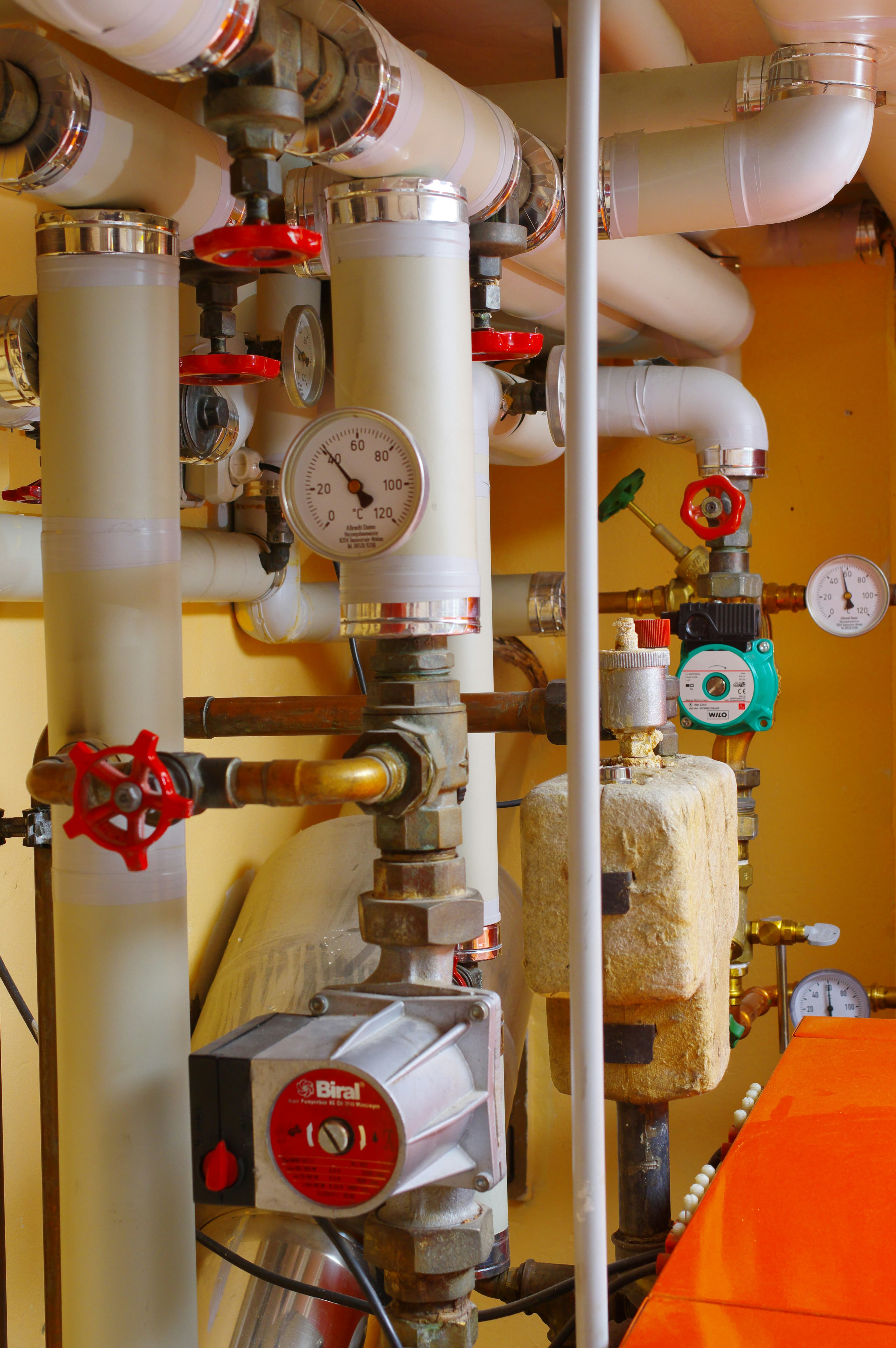 Boiler-room pipework, valves, and pressure gauges in a Connecticut home